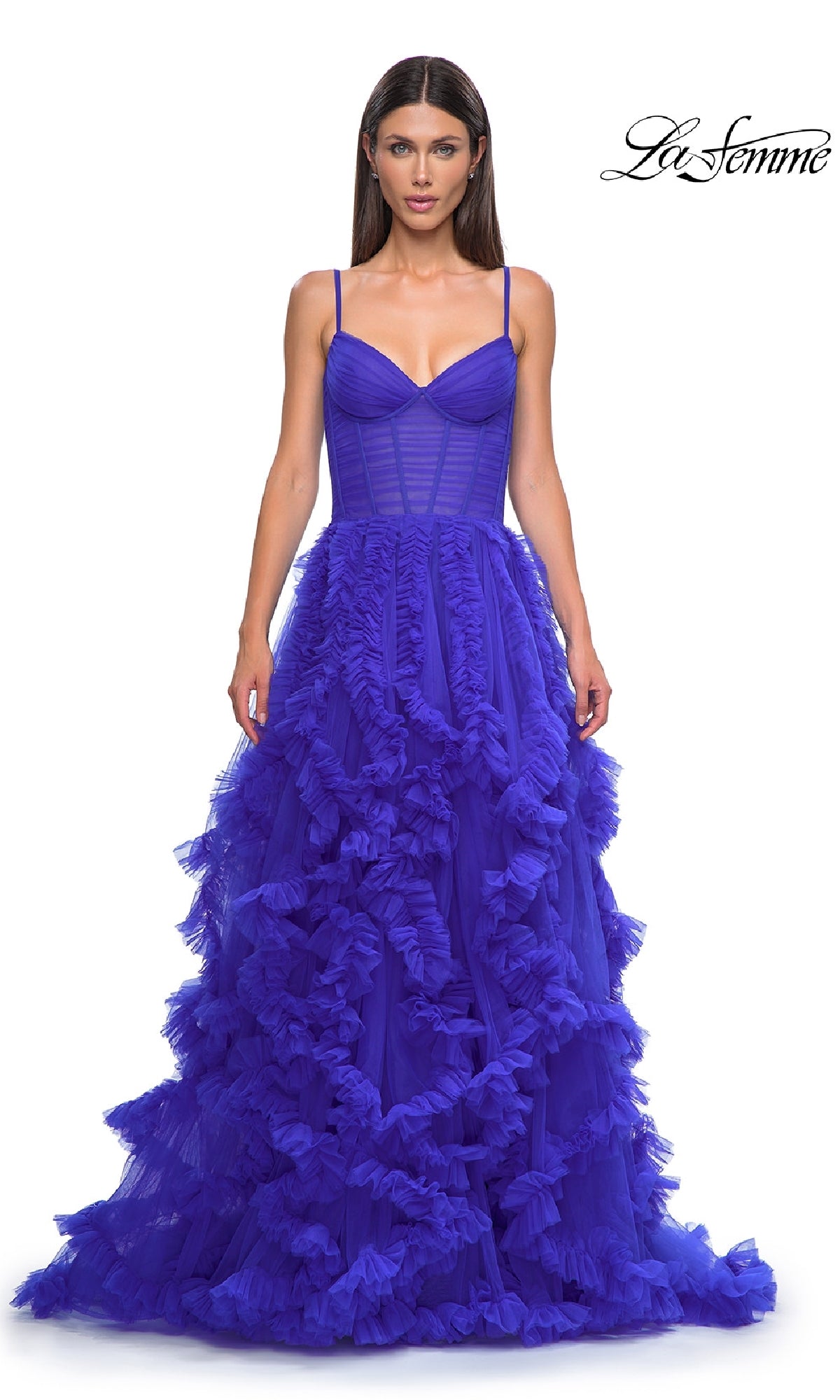 A woman wears the La Femme 32719 Ruffled-Tulle Long Prom Ball Gown in royal blue, featuring thin straps, a fitted lace corset bodice, and a layered ruffled tulle skirt.